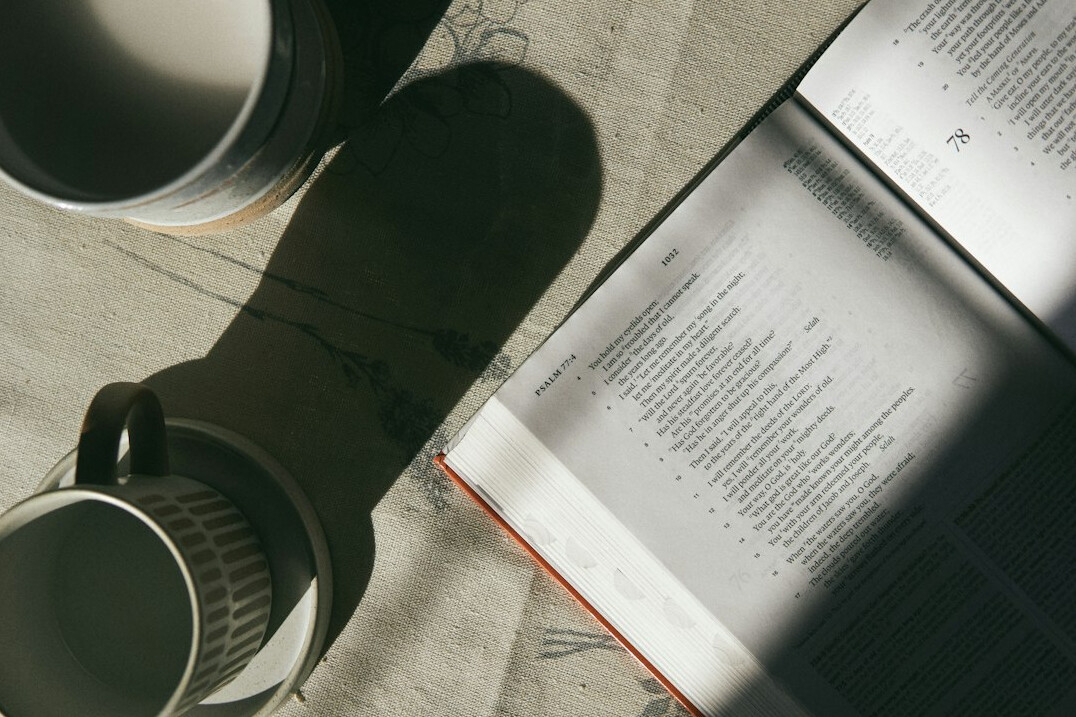 Research desk with open notebooks, documents and a cup of coffee