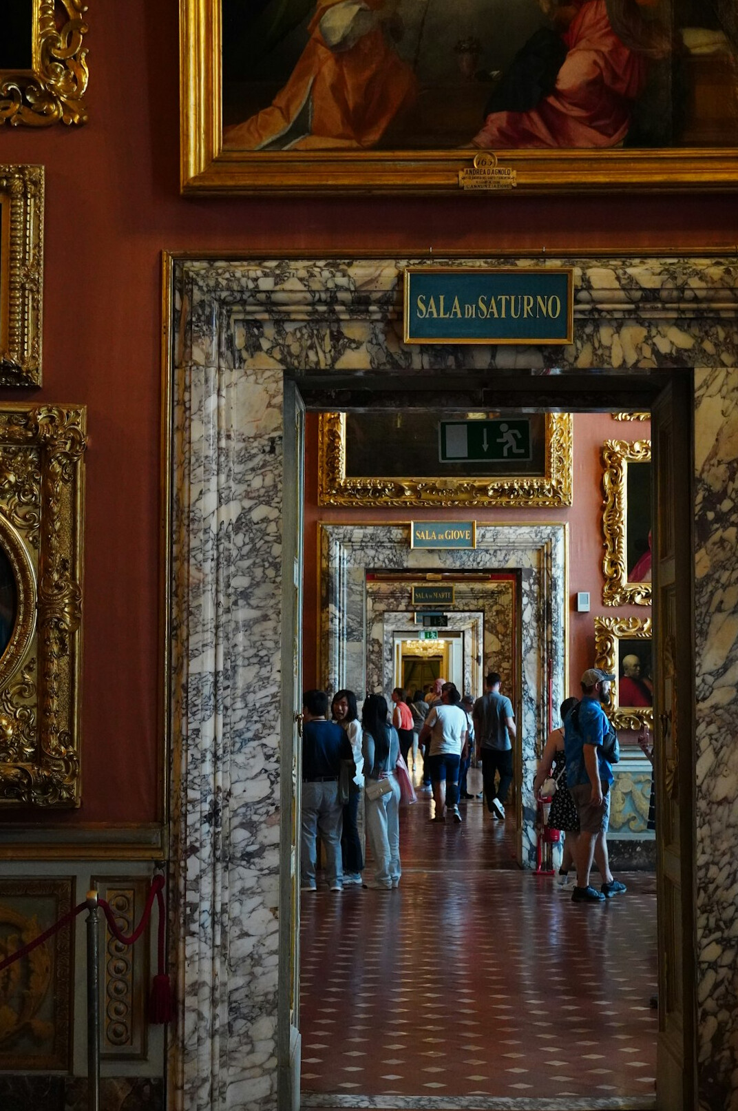 Person seen from behind walking through a museum corridor